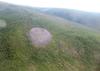 Патомский кратер в Иркутской области, представляет собой конусовидный холм, состоящий из дробленого известняка, диаметром до 180 метров и высотой 40 метров. 
Среди местного населения носит название «Г